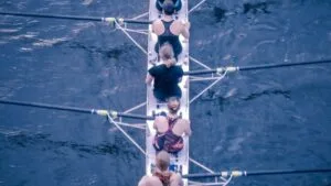Equipe féminine faisant de l'aviron pour illustrer l'article sur Ancrer l'apprentissage dans la réalité : un changement de comportement durable pour les équipes réelles